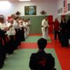 Dave Russell promoted to Black Belt, overseen by Hanshi LaLone and Hanshi Anzures.